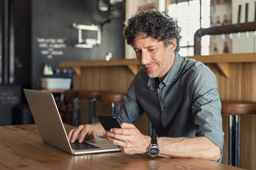 Man using laptop in coffee shop