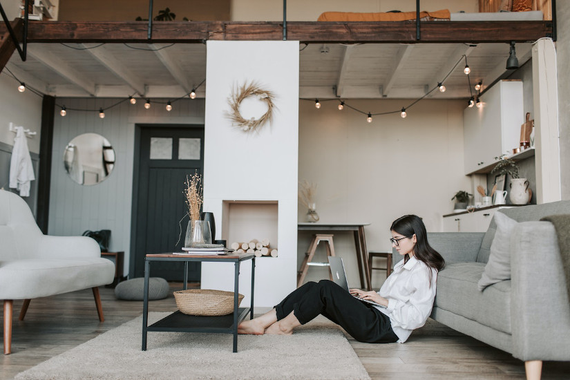 Woman using laptop on floor