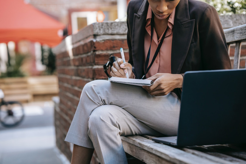 Woman studying on bench