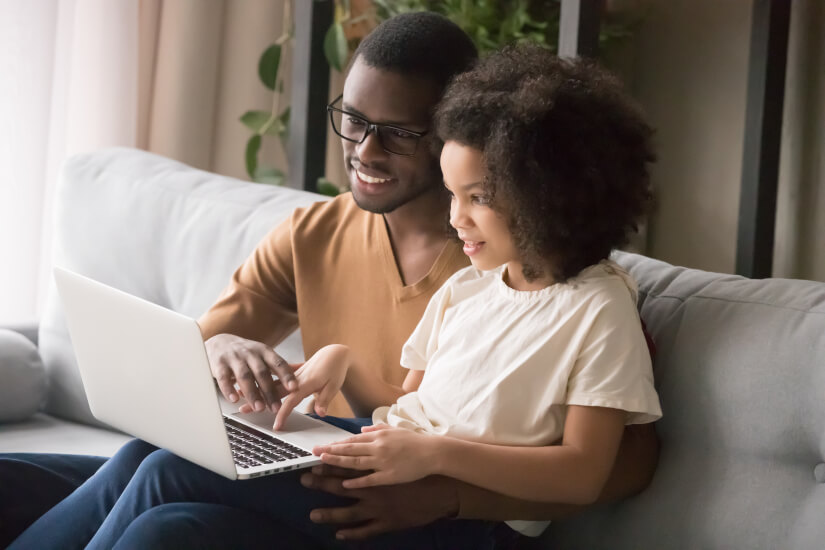 Father and daughter using computer