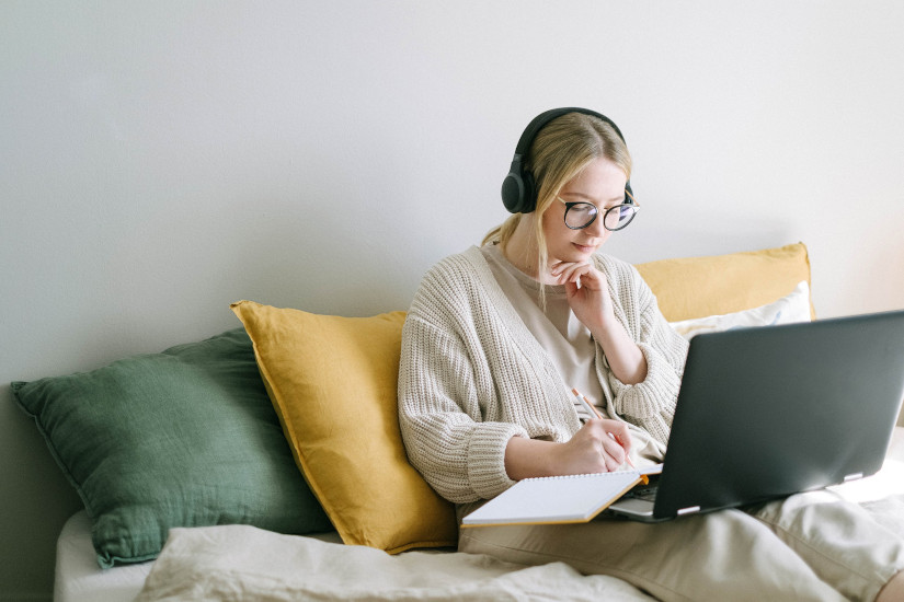 Woman using laptop in bed